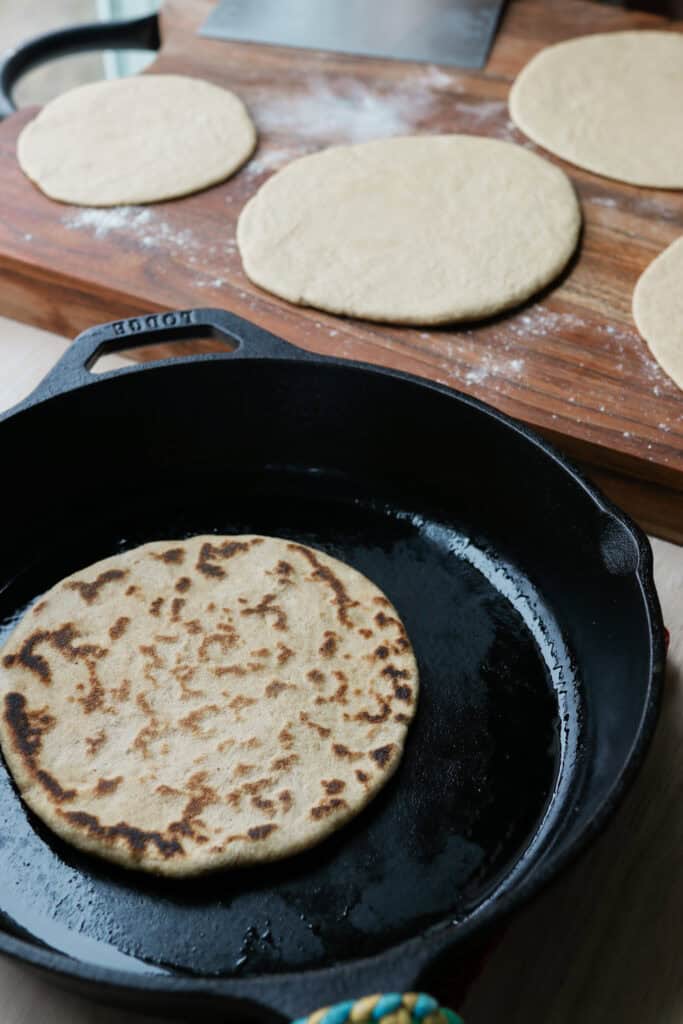 fresh milled sourdough tortillas in cast iron pan