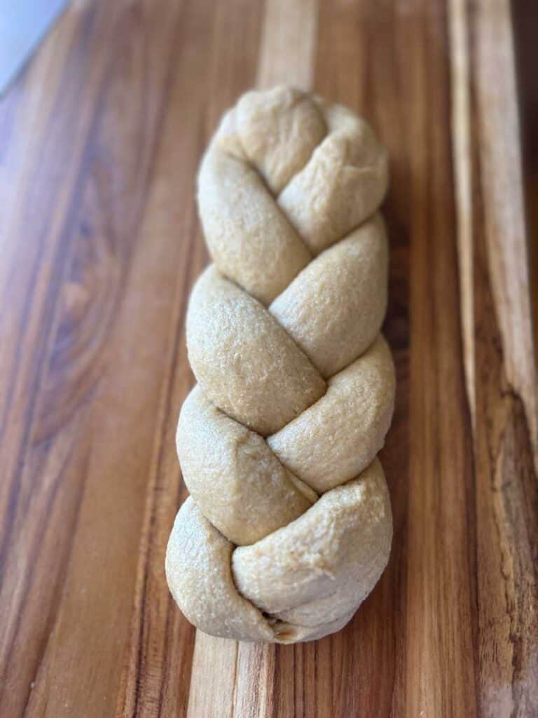 freshly milled brioche bread, braided and waiting to rise