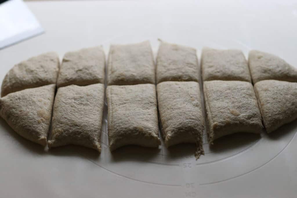pretzel bun dough cut into 12 pieces