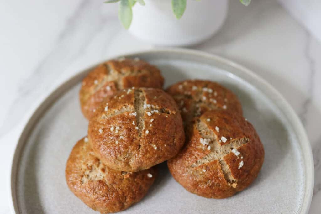 5 pretzel buns on a plate