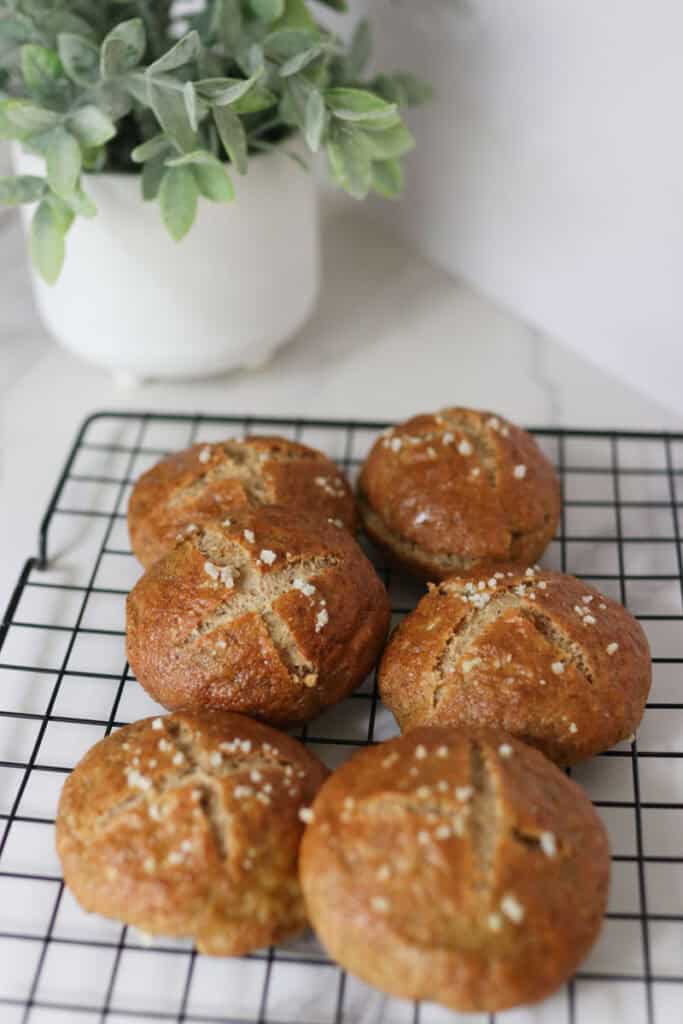 6 pretzel buns on a rack
