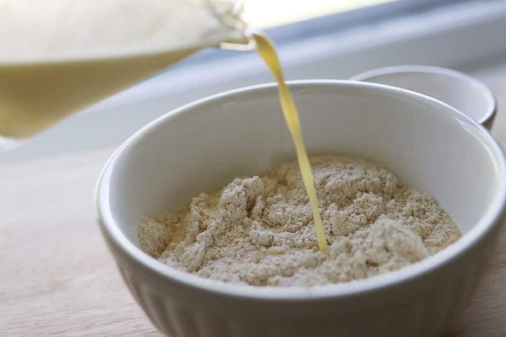 pouring wet ingredients into flour