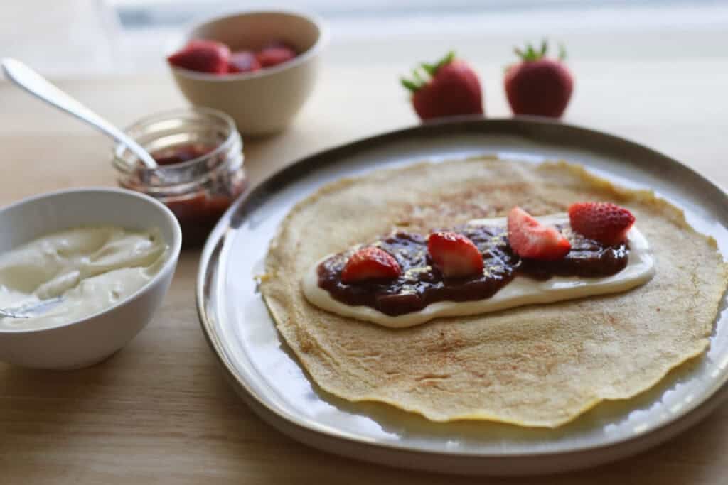 crepe on a plate with strawberries