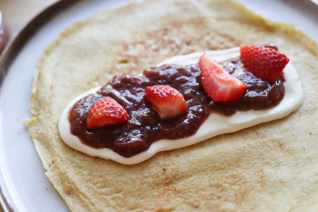 crepe filled with strawberries and whipped cream