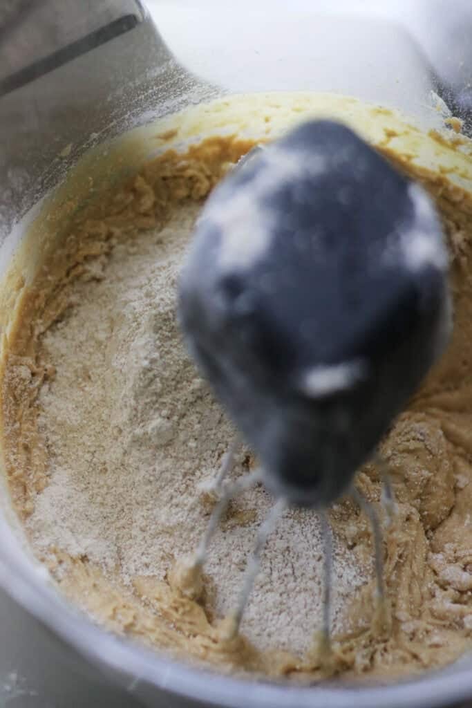 flour and baking soda being incorporated into cake batter