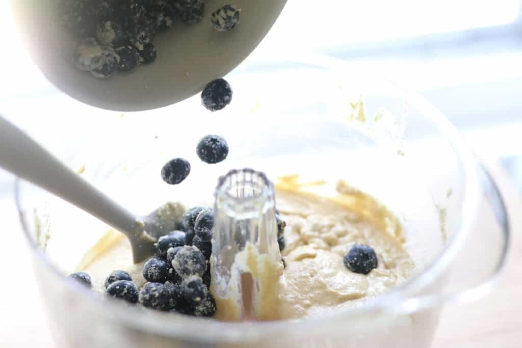 adding blueberries to cake batter