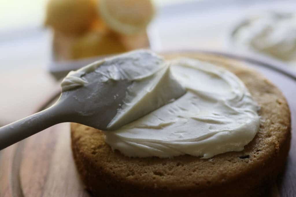 spreading icing on cake
