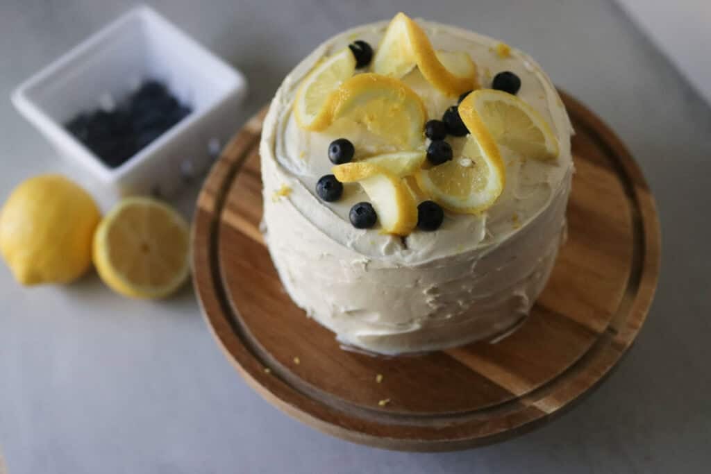 cake on stand with lemons and berries