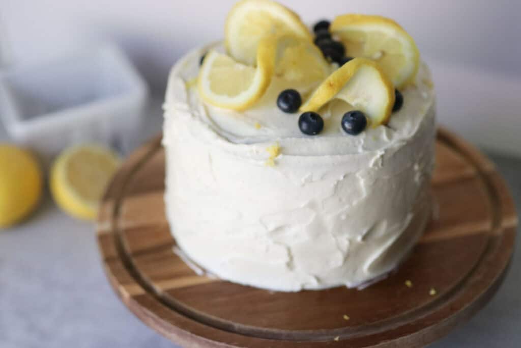 lemon blueberry cake with lemons in the background