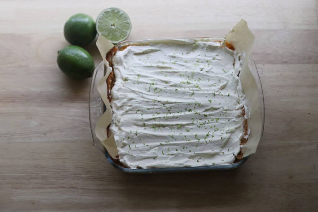 freshly milled key lime pie bars with limes in the background