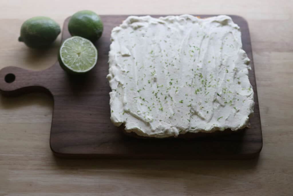 freshly milled key lime pie bars on a cutting board with fresh limes