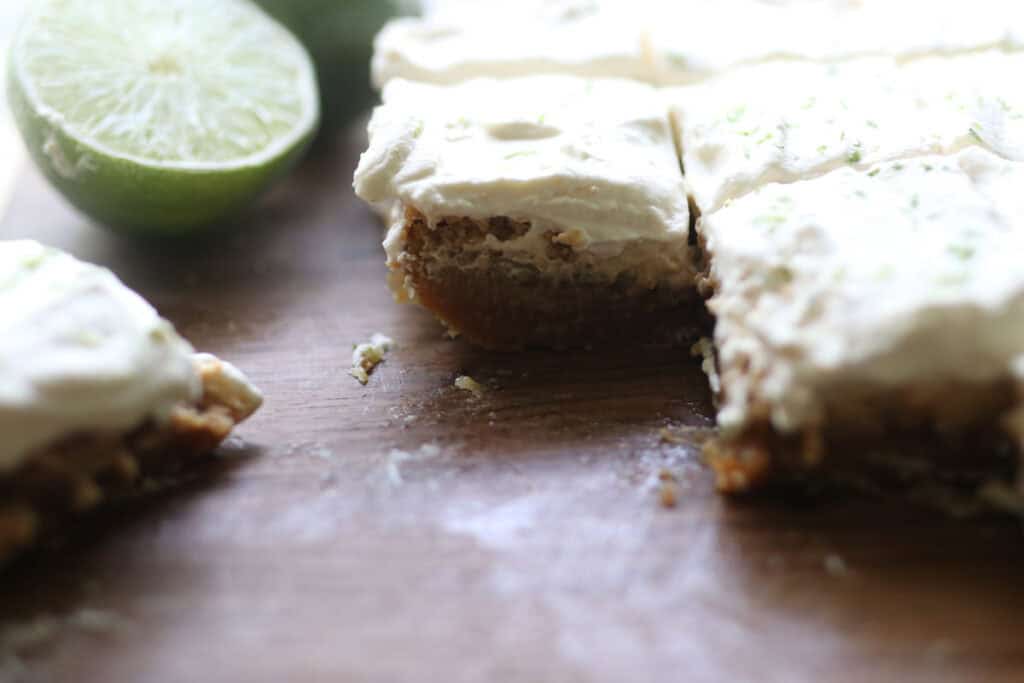 freshly milled key lime pie bars with homemade whipped cream and limes