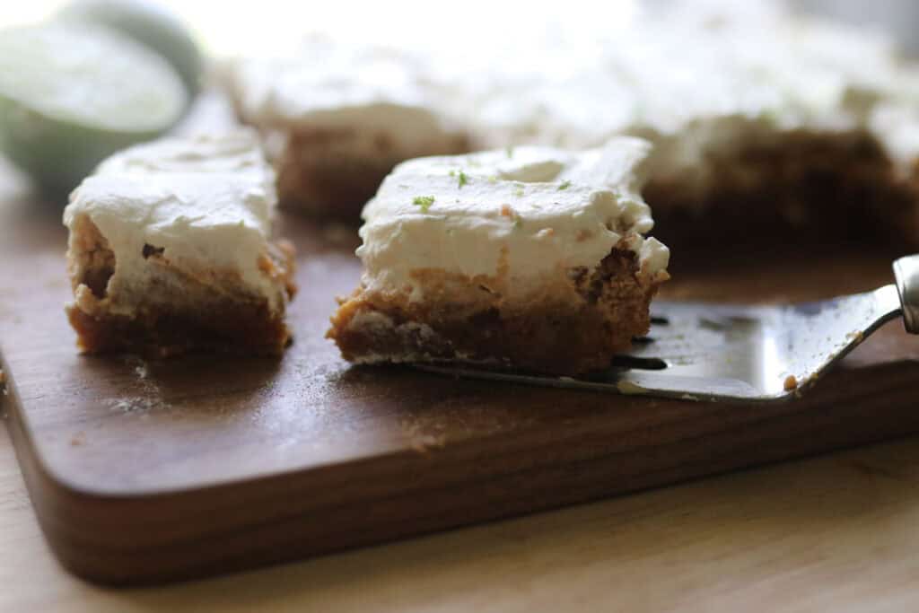a freshly milled key lime pie bars that has lime zest on top of it