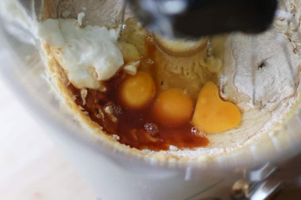 Eggs, yogurt, and vanilla in a mixing bowl