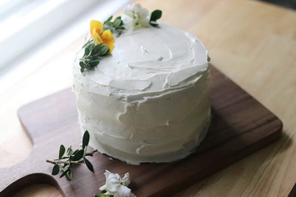 finished yellow cake with buttercream and flowers on top
