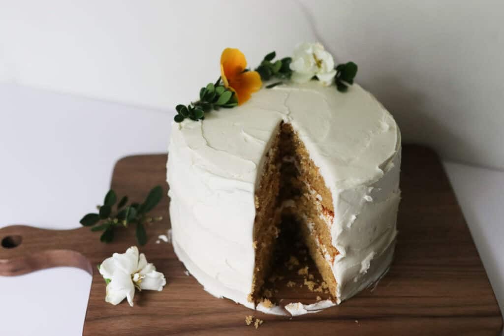 yellow cake with slice taken out on a cutting board