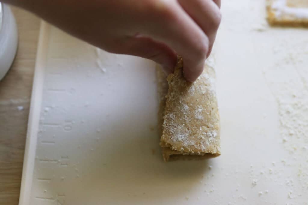 folding over the sides of a freshly milled nutrigrain bar