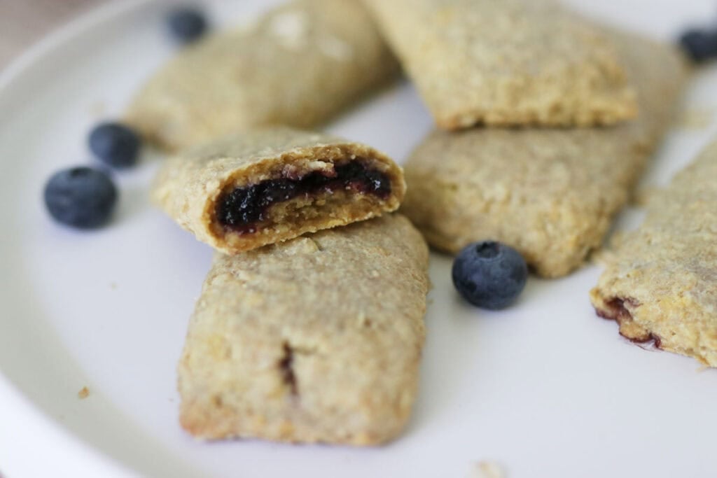 freshly milled blueberry nutrigrain bar cut in half on a plate
