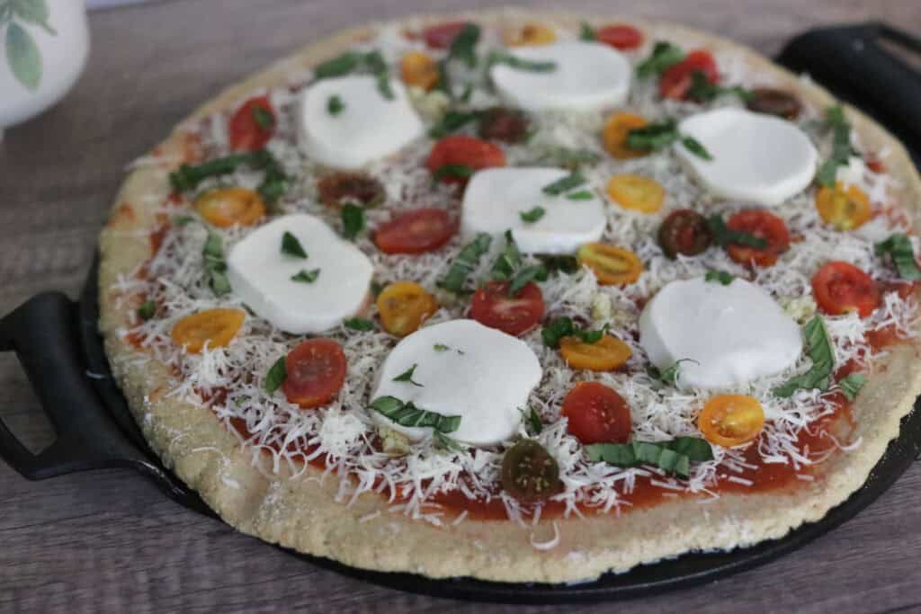 unbaked pizza crust with toppings on it