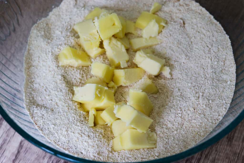 cubed butter in a bowl of flour