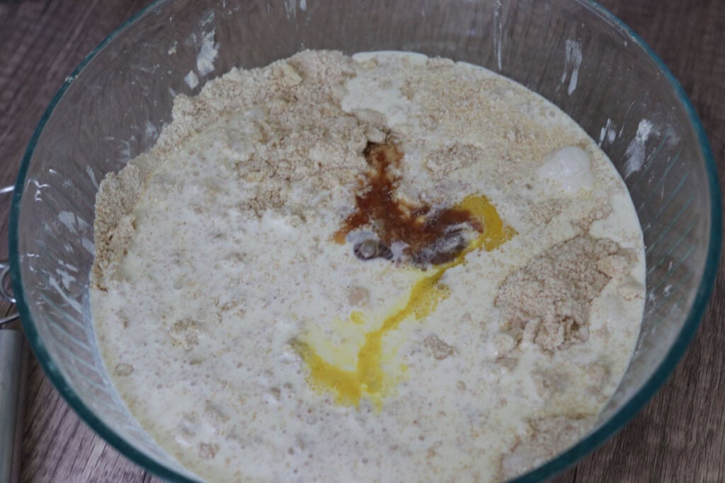 eggs, vanilla, and heavy cream in a mixing bowl with flour.