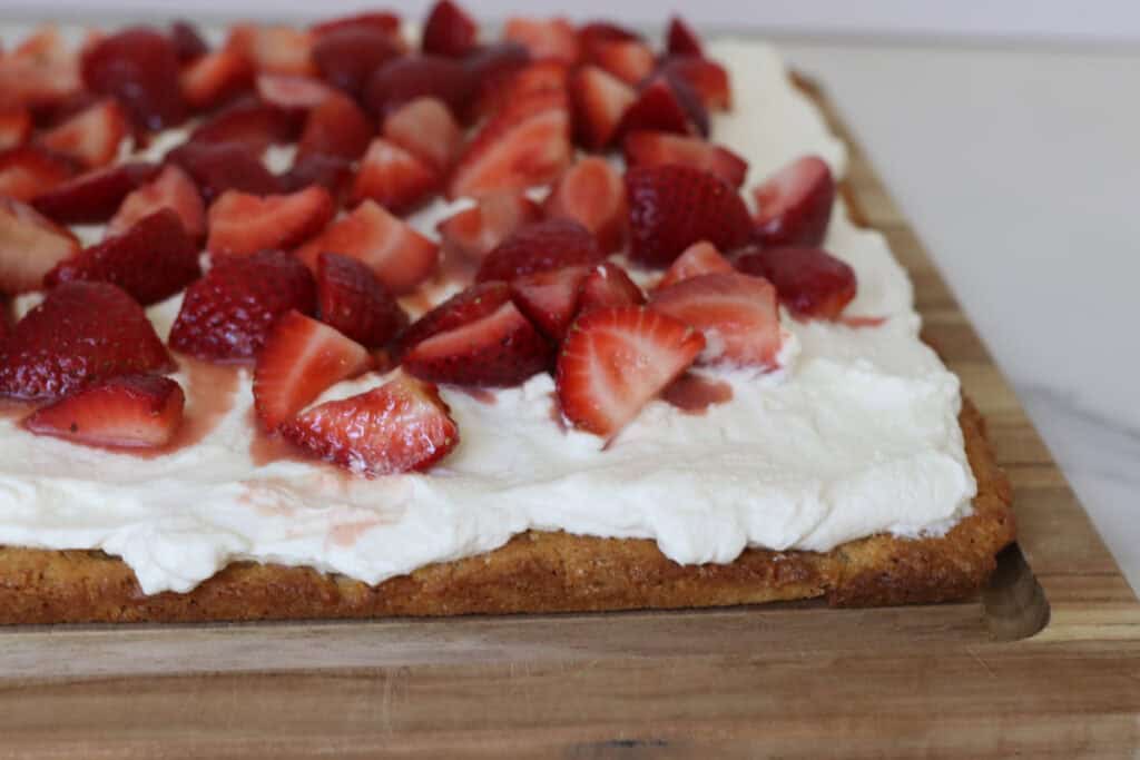 strawberries on a cake with whipped cream