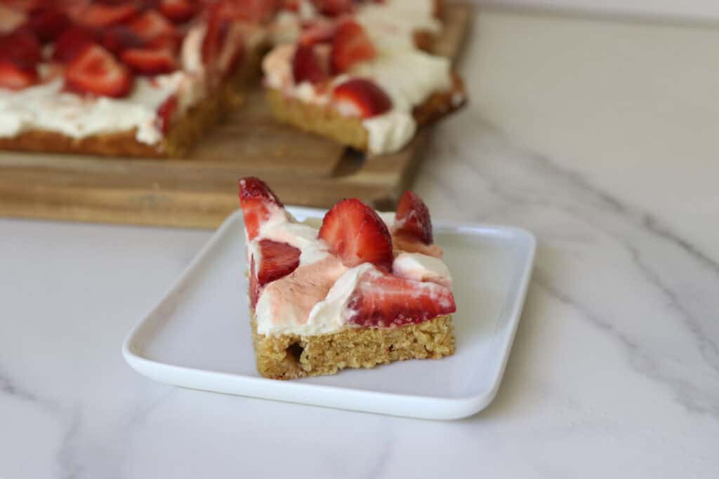 a piece of freshly milled strawberry shortcake sitting on plate