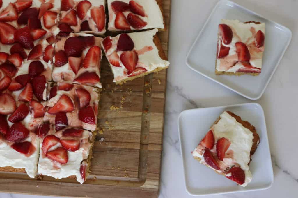 two slices of strawberry shortcake on plates