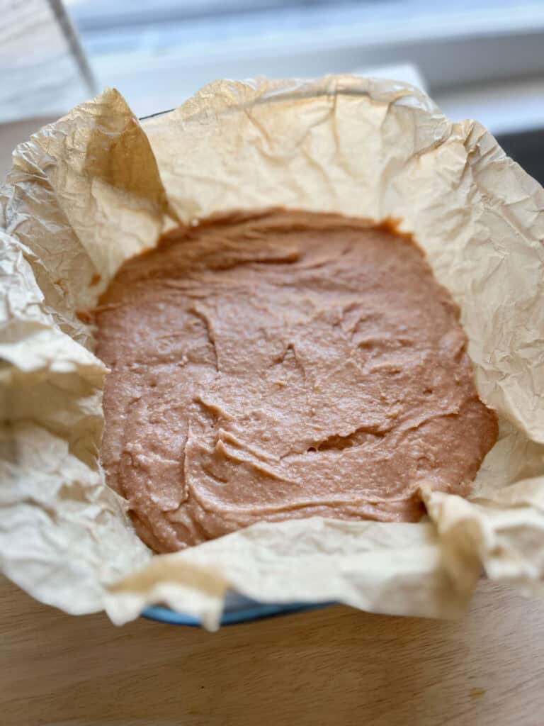 strawberry brownie batter in square pan