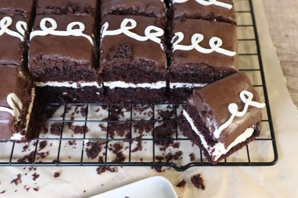 sliced fresh milled hostess sheet cake on a baking rack