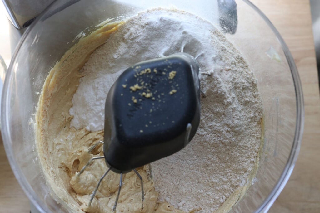 flour being added to cake batter for the freshly milled lemon chantilly cake