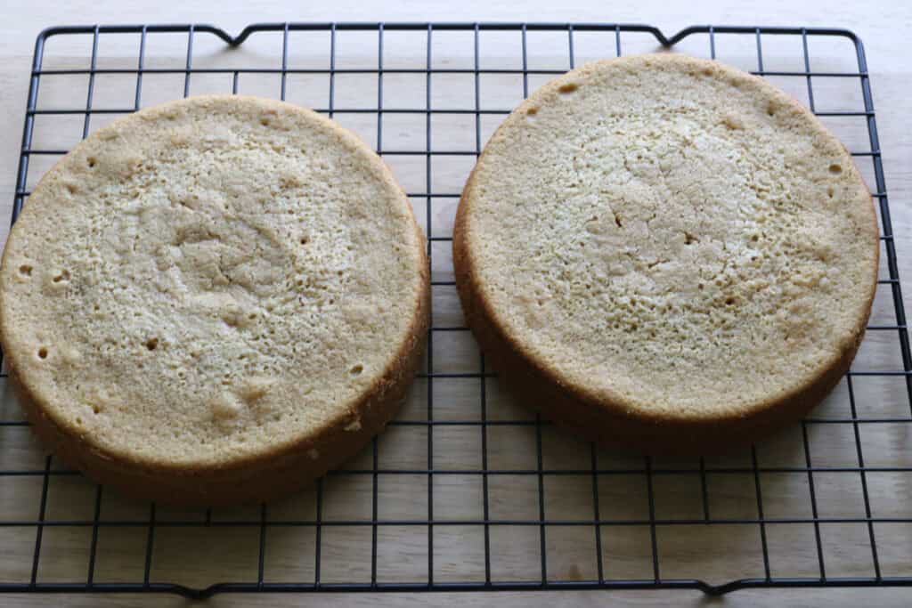 freshly milled lemon chantilly cake cooling on a wire rack