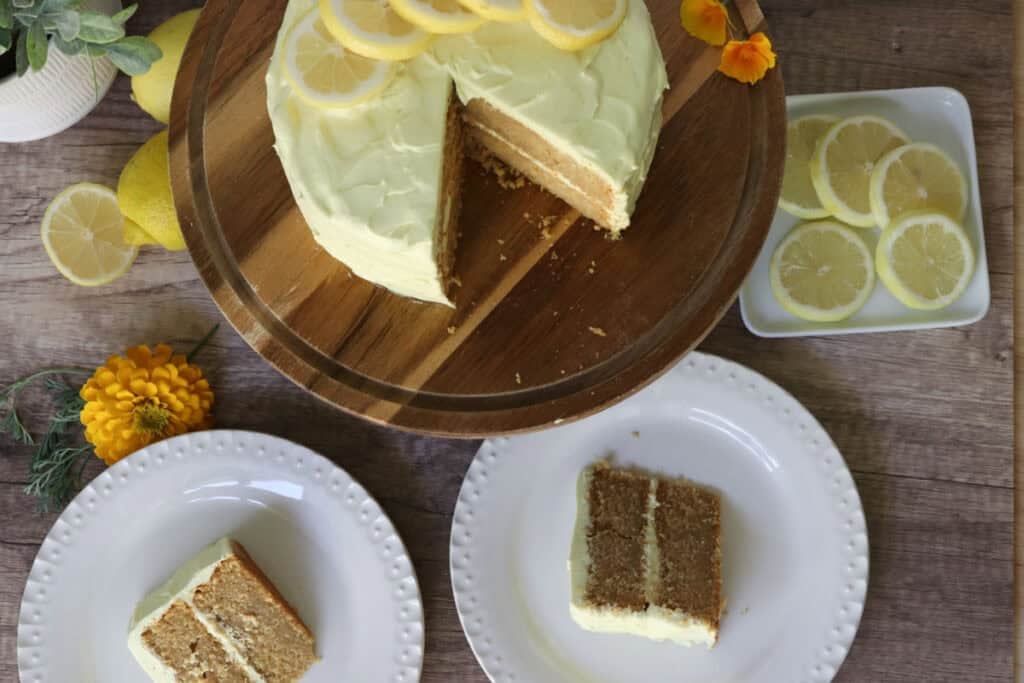 freshly milled lemon chantilly cake with two slices of cake on white plates