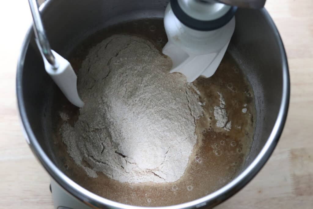 flour, water, and sugar in a mixing bowl to make twisted apple cinnamon loaf with fresh milled flour