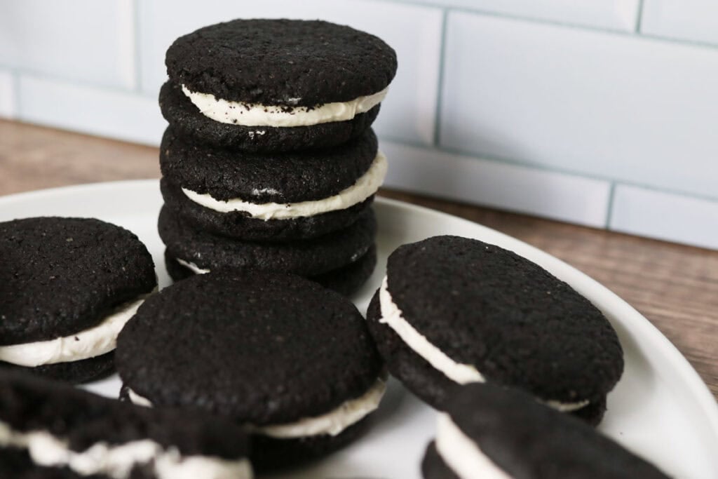 fresh milled homemade oreos that are stacked on a white plate