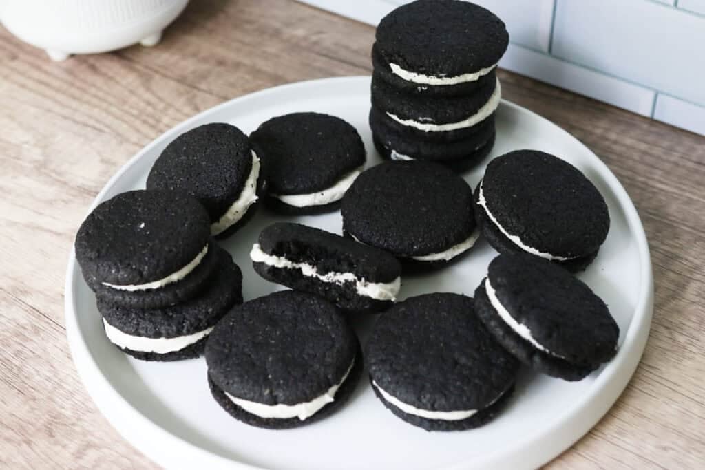 delicious homemade fresh milled homemade oreos on a white plate with a bite taken out 
