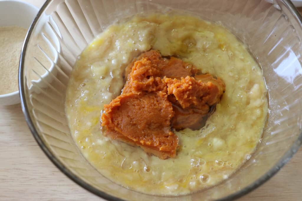 pumpkin puree and mashed banana in a bowl to make fresh milled pumpkin chocolate chip banana bread