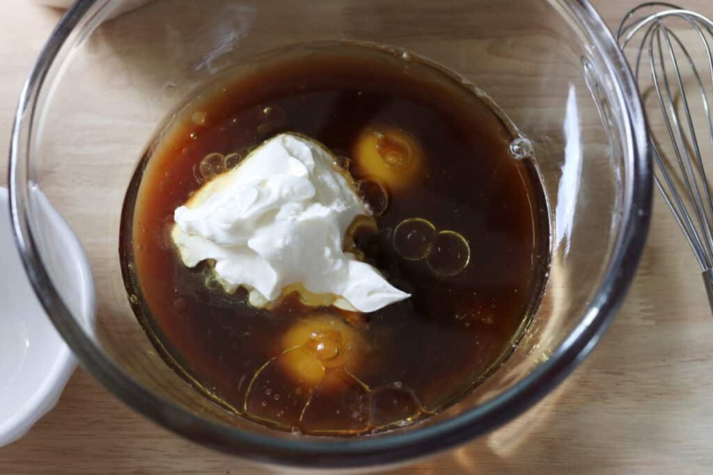 coffee and sour cream in a bowl to make freshly milled chocolate chip cappuccino muffins