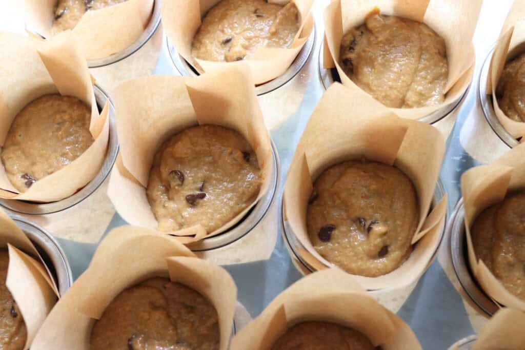 freshly milled chocolate chip cappuccino muffins in a muffin pan with liners