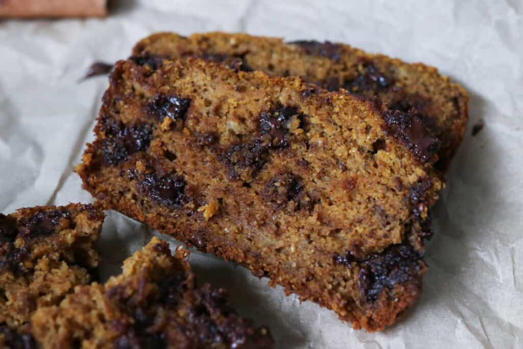 two slices fresh milled pumpkin banana bread with chocolate chips in it