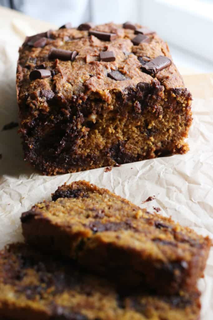 fresh milled pumpkin chocolate chip banana bread on a piece of parchment paper