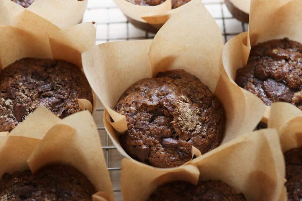 freshly milled chocolate chip cappuccino muffins on a wire rack with muffin liners