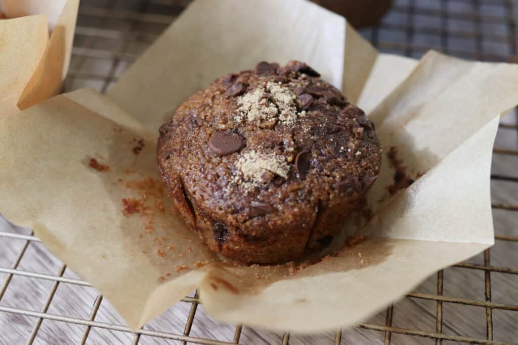 a freshly milled chocolate chip cappuccino muffin in a paper liner