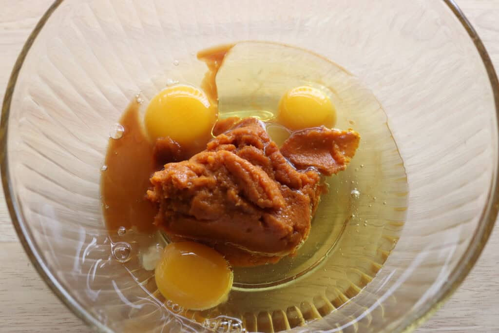 pumpkin puree, eggs, and oil in a bowl to make fresh milled cinnamon sugar pumpkin cake donuts