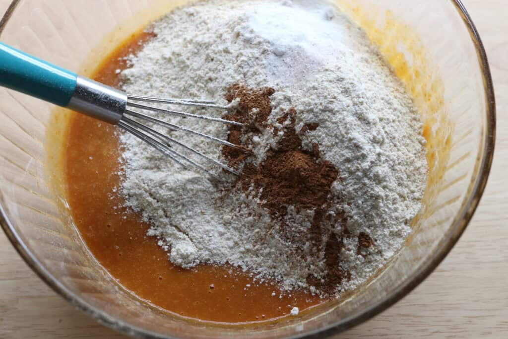 flour and cinnamon in a bowl to make fresh milled cinnamon sugar pumpkin cake donuts