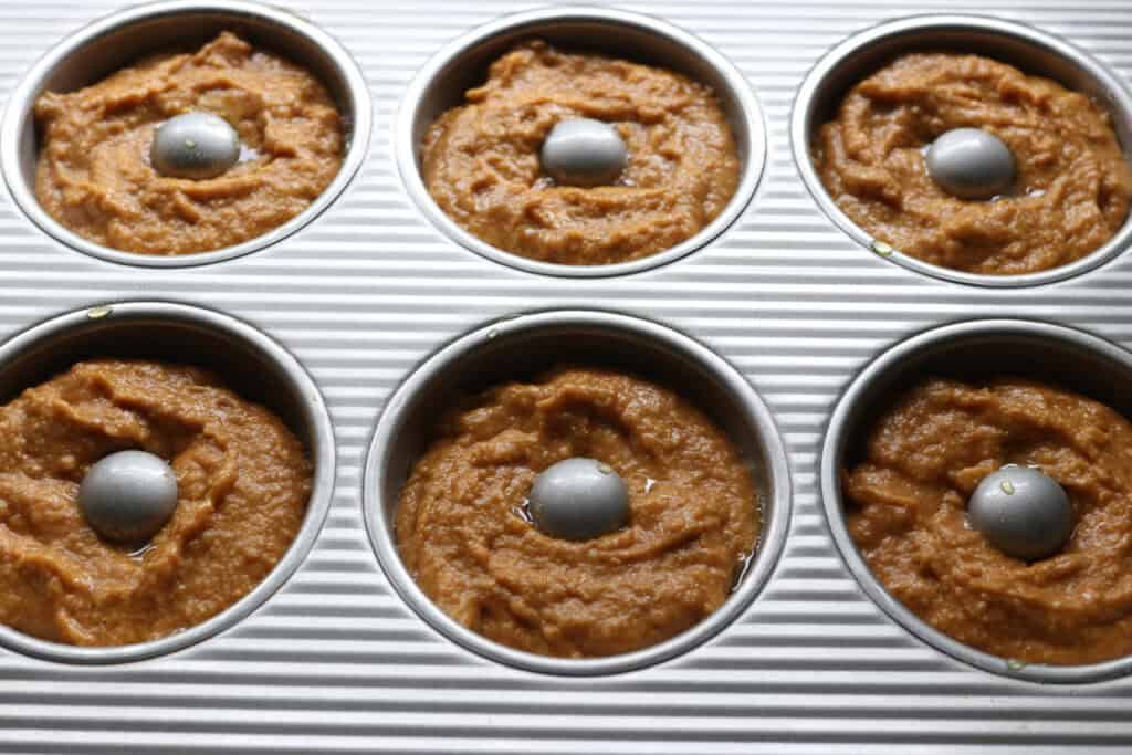 fresh milled cinnamon sugar pumpkin cake donut batter in a donut pan