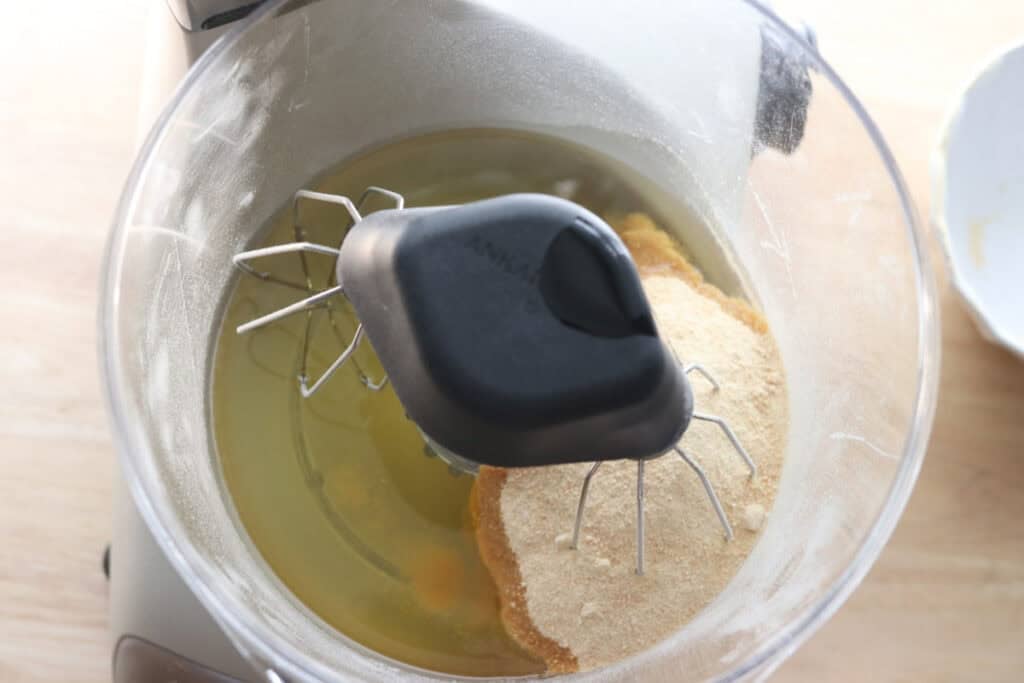 sugar and oil in a mixing bowl to make freshly milled carrot cake with cream cheese icing