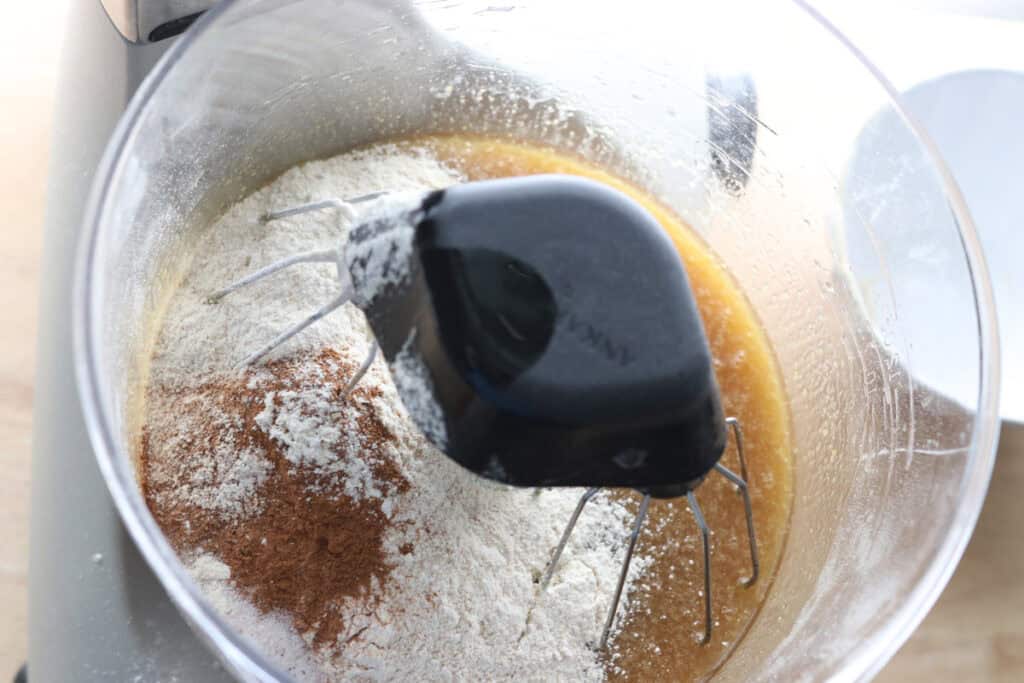 flour and cinnamon in a mixing bowl to make freshly milled carrot cake with cream cheese icing