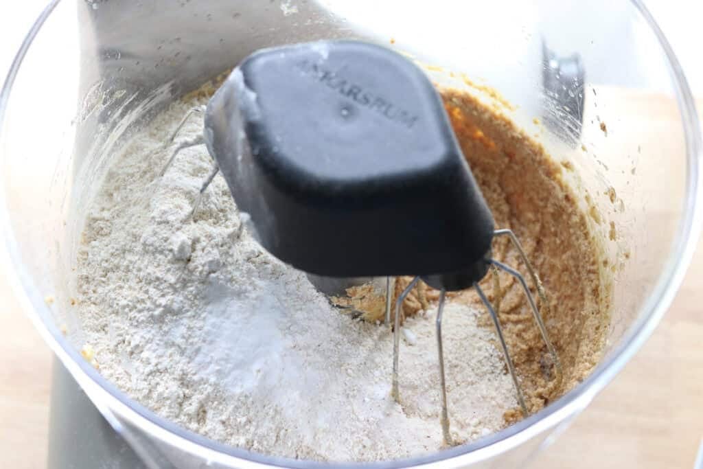 adding flour to a bowl to make fresh milled maple brown sugar cookies