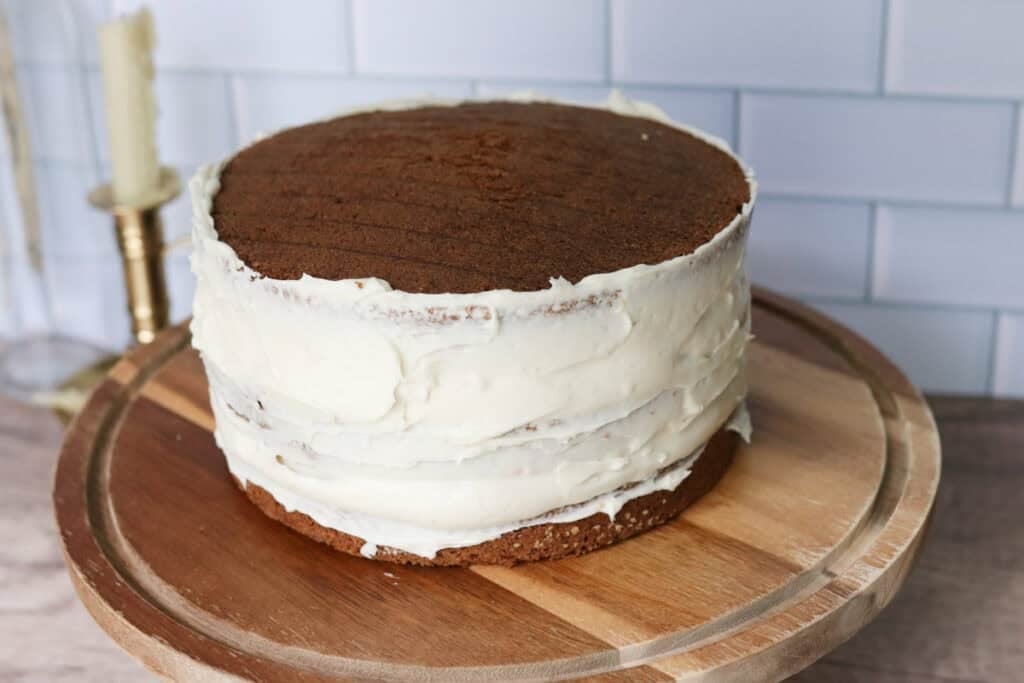 3 layers of freshly milled carrot cake with cream cheese icing on the sides